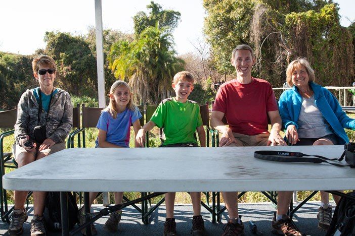 The Earth Trekkers and family members enjoying the views from a boat tour on the Chobe River.