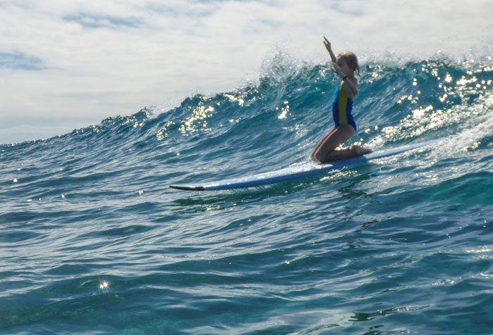 Kara surfing in Fiji.