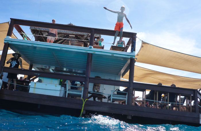 Tyler jumping into the ocean from the upper level of Cloud 9 in Fiji.