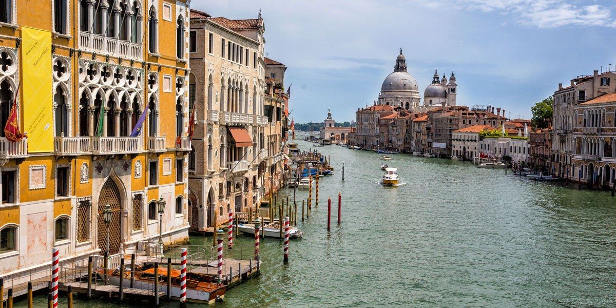 a water way with boats and buildings in the background