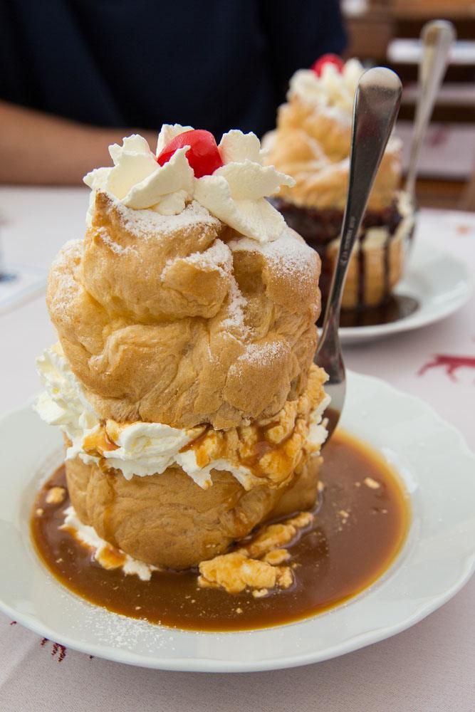 Windbeutel (German cream puff) in a white plate. 