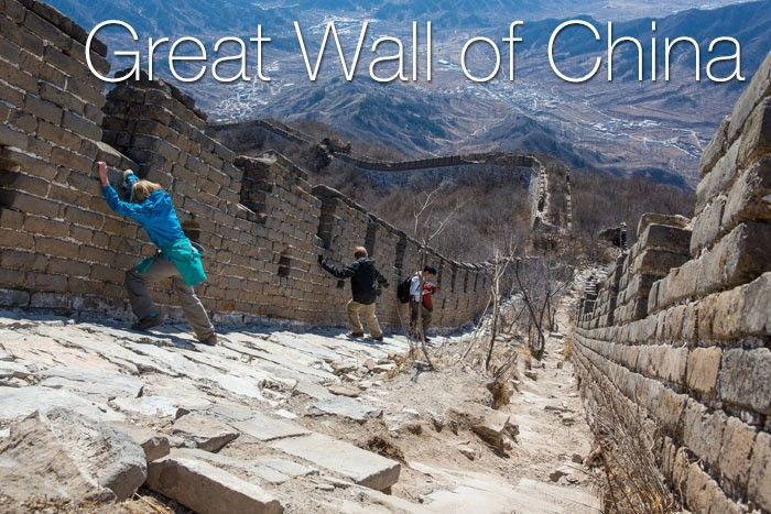 A group of tourists rests while walking on the Great Wall of China.